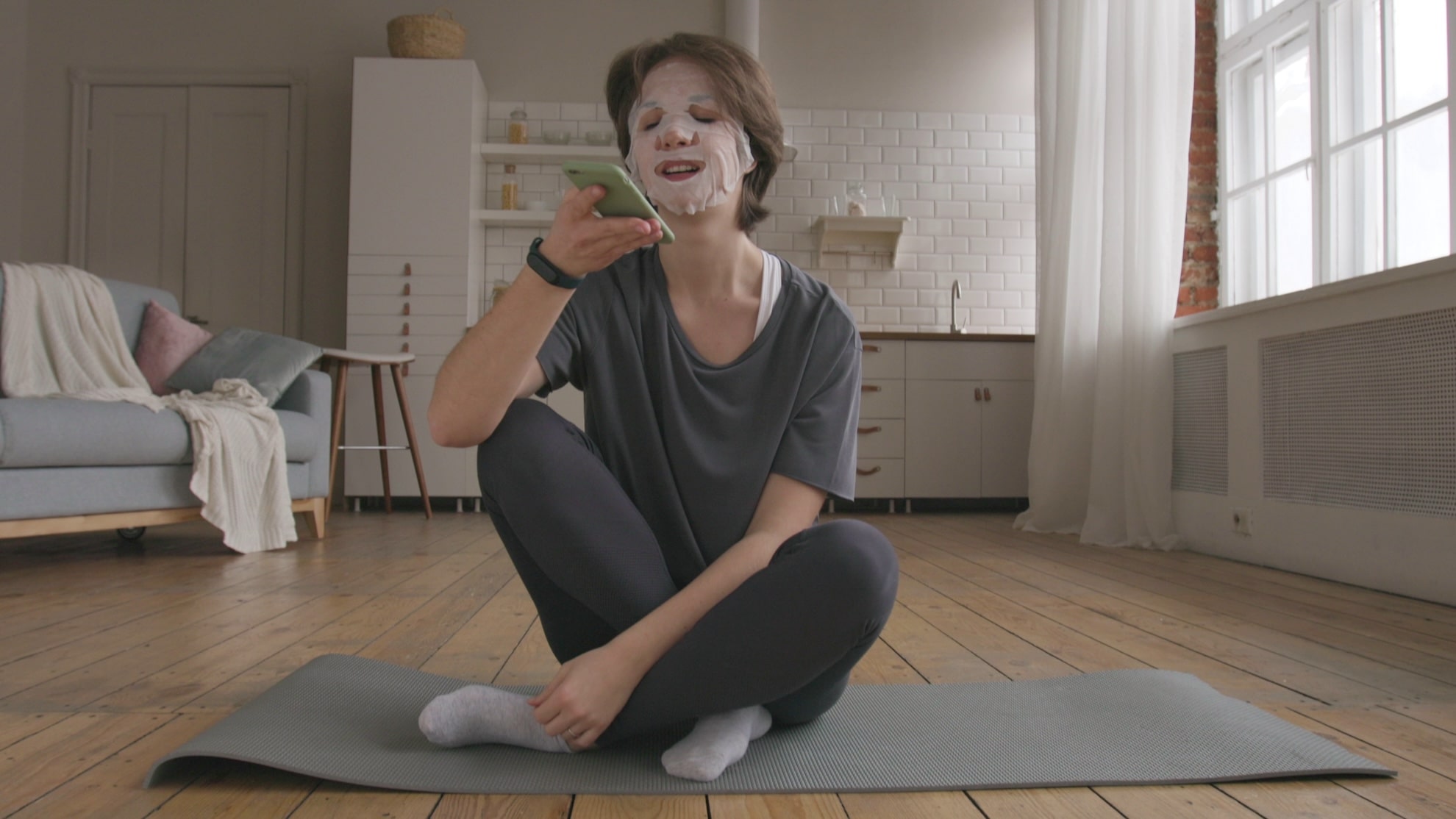 young woman applies paper mask after her fitness training young freelancer daily routi SBI 350689772 min